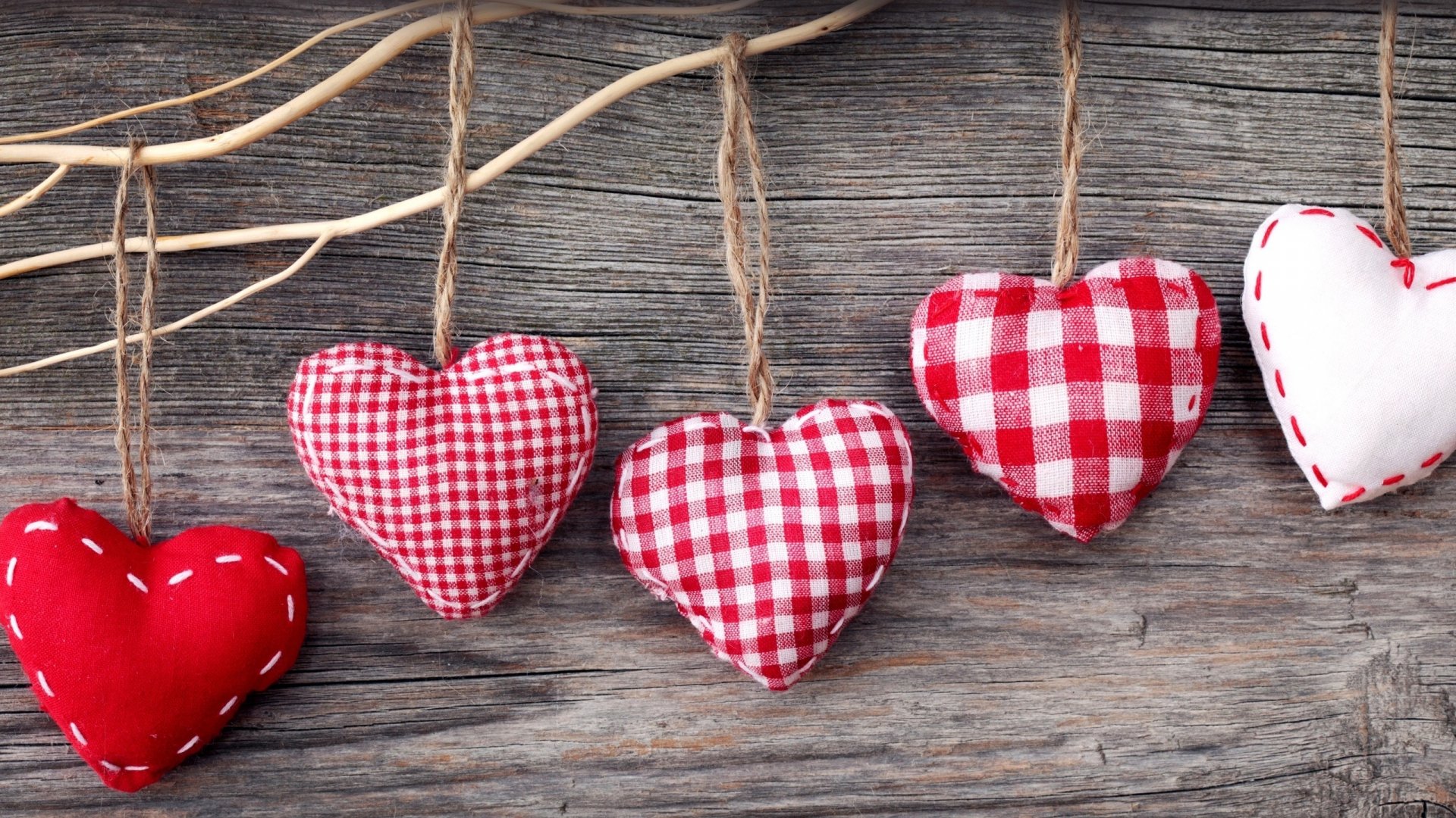 HD desktop wallpaper featuring red and white fabric hearts hanging on twine against a rustic wooden background, celebrating Valentine's Day holiday.
