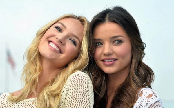 HD desktop wallpaper featuring models Candice Swanepoel and Miranda Kerr, both smiling and showcasing their beauty in a natural setting.