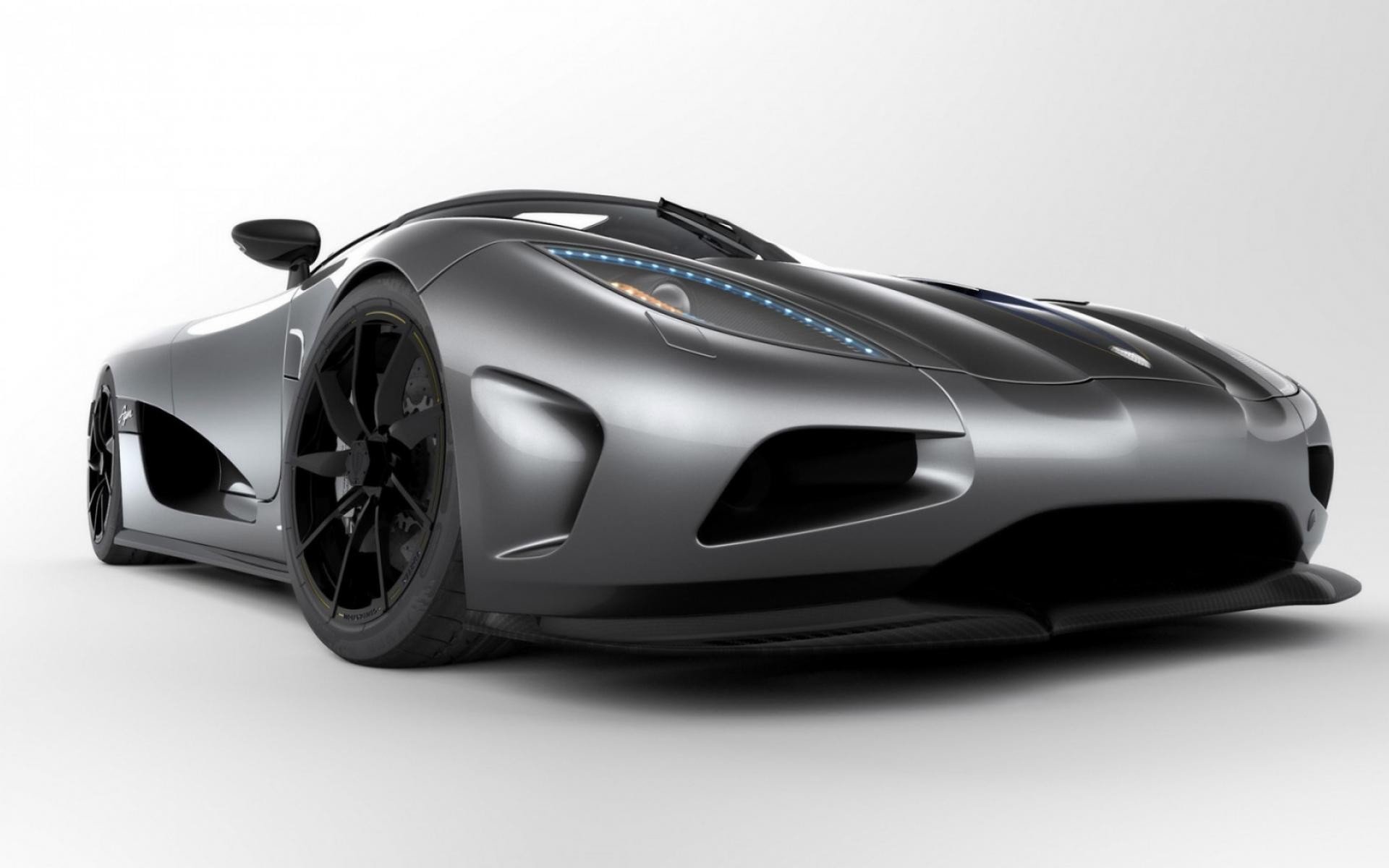 HD wallpaper featuring a sleek, gray Koenigsegg Agera sports car against a minimalistic white backdrop.