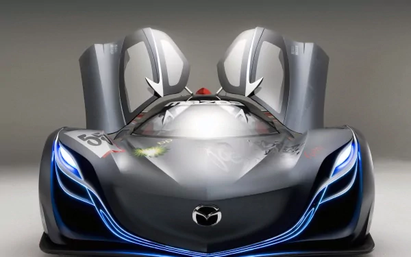 HD PC desktop wallpaper of a Mazda Furai vehicle — a sleek dark metallic concept car with glowing blue accents and upward-opening gullwing doors.