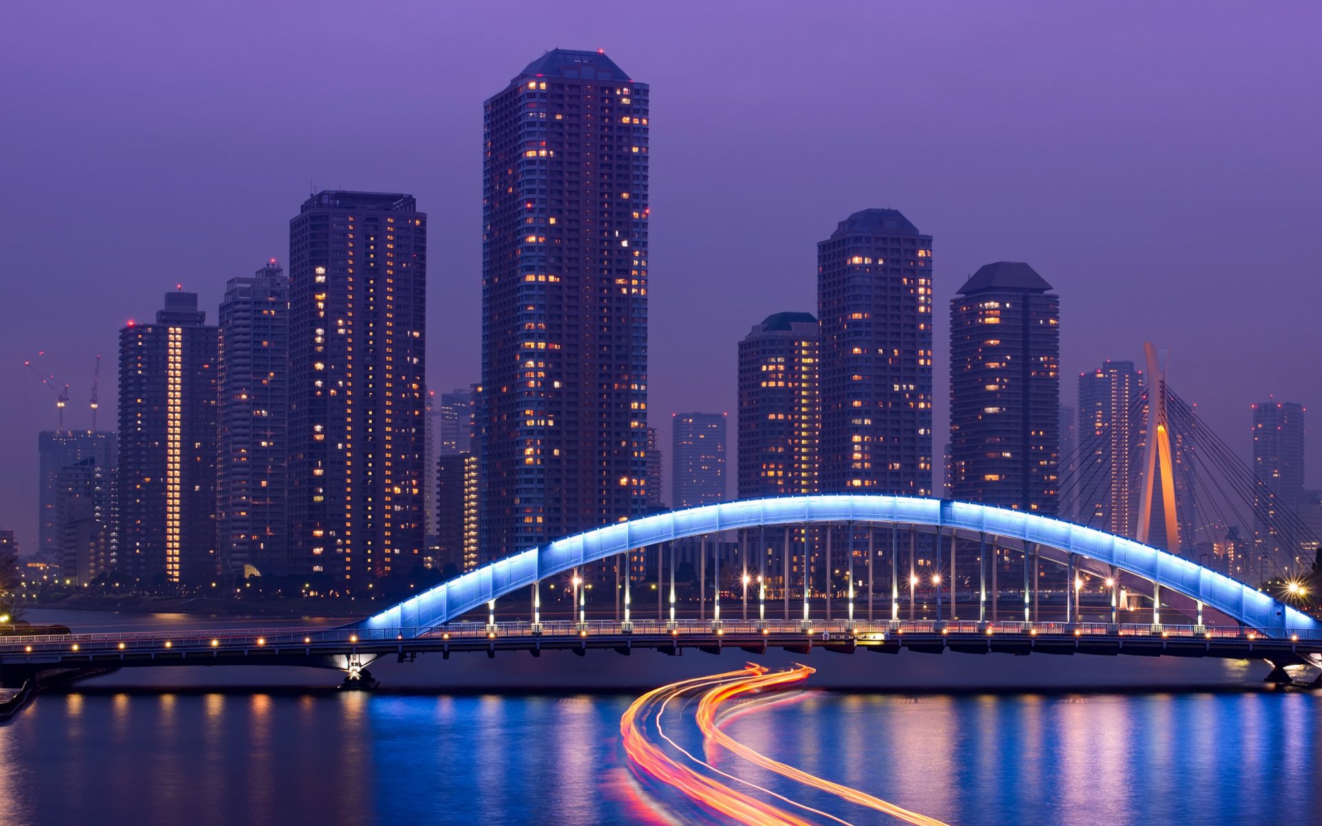 Chuo-Ohashi and Eitai Bridges at twilight in Tokyo, Japan — illuminated arch and river light trails; 2K Quad HD desktop wallpaper of a man-made cityscape.