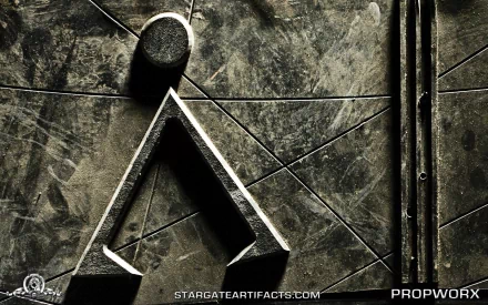 A detailed close-up of a stone texture featuring an emblem from the TV show Stargate SG-1, suitable as a striking HD desktop wallpaper or background.