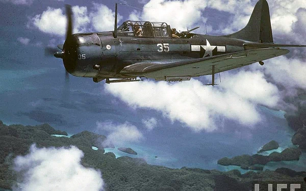HD PC desktop wallpaper: military Douglas SBD Dauntless dive bomber flying over tropical islands and clouds.