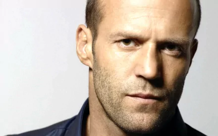 A striking HD PC desktop wallpaper featuring celebrity Jason Statham, showcasing his intense gaze and strong profile against a neutral background.