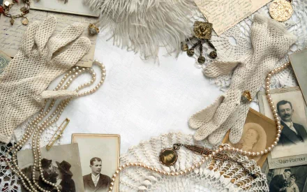 A vintage-themed HD desktop wallpaper featuring elegant gloves, pearls, old photographs, lace, and antique items, creating a nostalgic and timeless atmosphere.