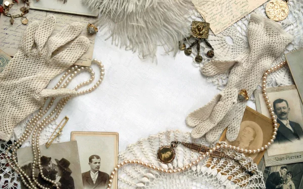 A vintage-themed HD desktop wallpaper featuring elegant gloves, pearls, old photographs, lace, and antique items, creating a nostalgic and timeless atmosphere.
