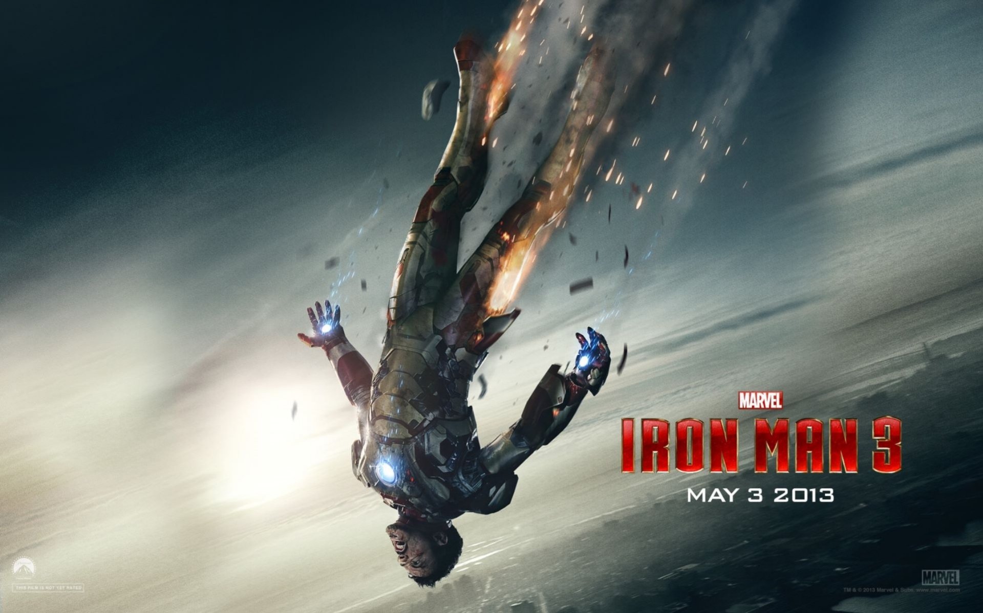 An action-packed HD wallpaper featuring Tony Stark, portrayed by Robert Downey Jr., in a dynamic pose from the movie Iron Man 3, released on May 3, 2013.