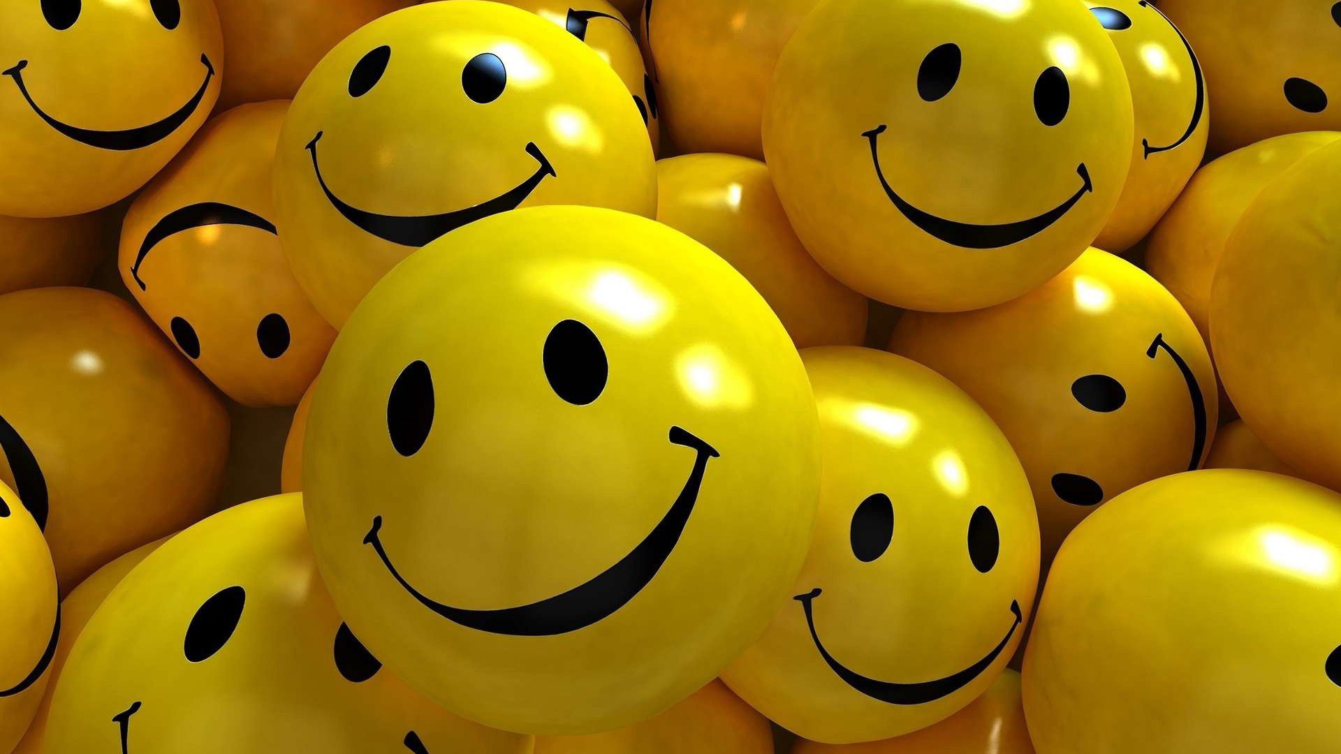Funny, smiley HD PC desktop wallpaper: glossy yellow smiley-face balls piled close together, big black grins filling the frame.