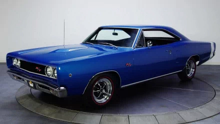 HD PC desktop wallpaper showing a blue Dodge Coronet classic muscle car in three-quarter view on a neutral studio backdrop.