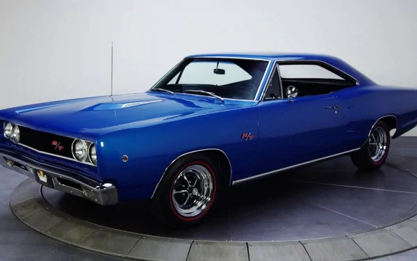 HD PC desktop wallpaper showing a blue Dodge Coronet classic muscle car in three-quarter view on a neutral studio backdrop.