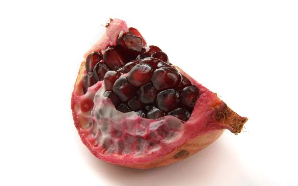 Close-up of a vibrant pomegranate section showcasing glossy red seeds, presented as a 4K Ultra HD PC desktop wallpaper and background centered on food.