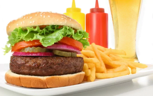 A delicious burger with lettuce, tomato, onion, and pickles, accompanied by golden fries and colorful condiments, set against a vibrant background. 4K Ultra HD desktop wallpaper.