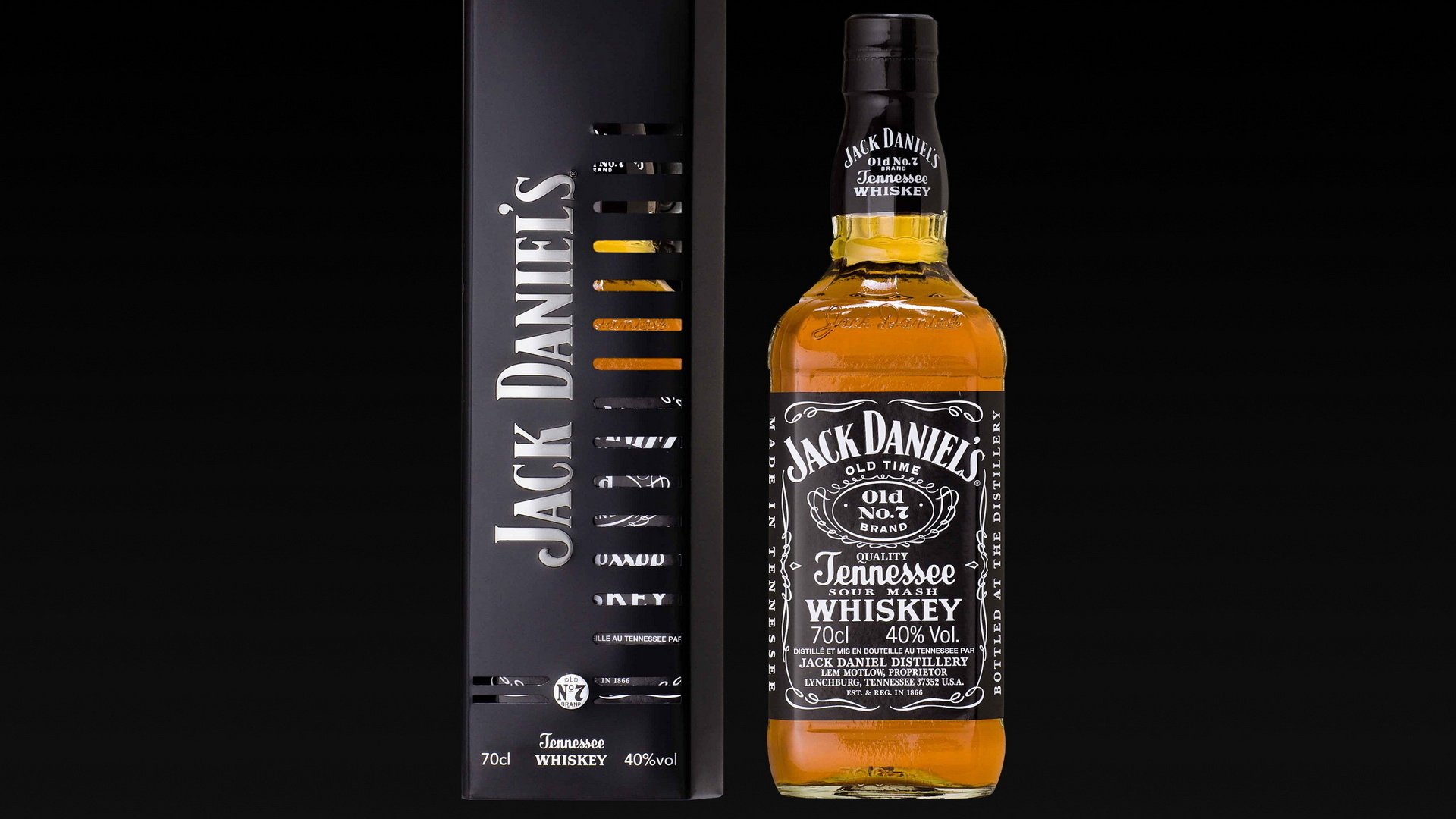 A sleek HD wallpaper featuring a bottle of Jack Daniel's Tennessee whiskey alongside its black box packaging, set against a contrasting dark background.