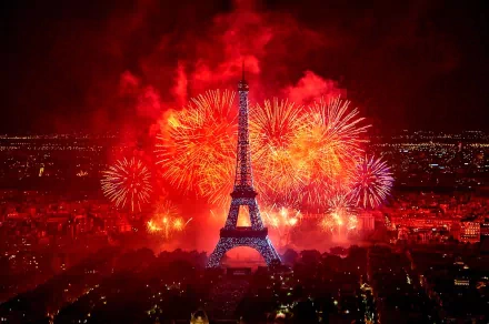 HD PC desktop wallpaper background photography: Eiffel Tower at night with blazing red fireworks over Paris and glowing city lights below.