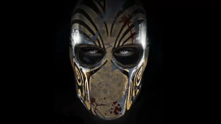 A striking HD wallpaper featuring a menacing mask from the video game Army of Two: The Devil's Cartel, showcasing intricate designs and a dark, atmospheric background.