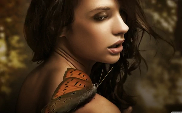 HD desktop wallpaper featuring a beautiful woman with long dark hair, a butterfly resting on her bare shoulder, set against a softly blurred natural background.