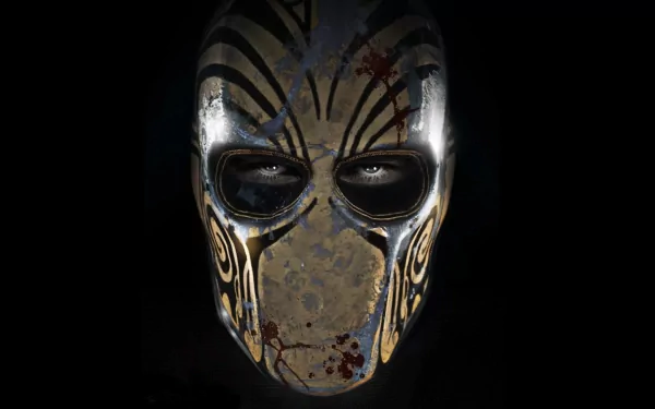 A striking HD wallpaper featuring a menacing mask from the video game Army of Two: The Devil's Cartel, showcasing intricate designs and a dark, atmospheric background.