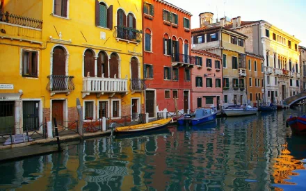 HD PC desktop wallpaper/background of man-made colorful waterfront buildings and moored boats along a Venetian canal in Venice.