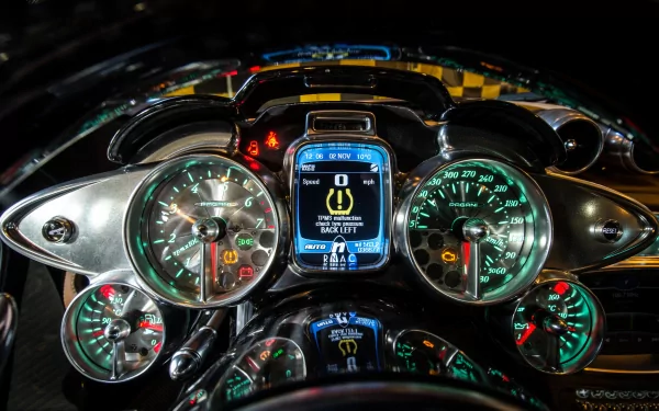 Detailed view of the dashboard of a Pagani Huayra, showcasing its sleek design and high-tech instrumentation. This HD image serves as a striking desktop wallpaper.