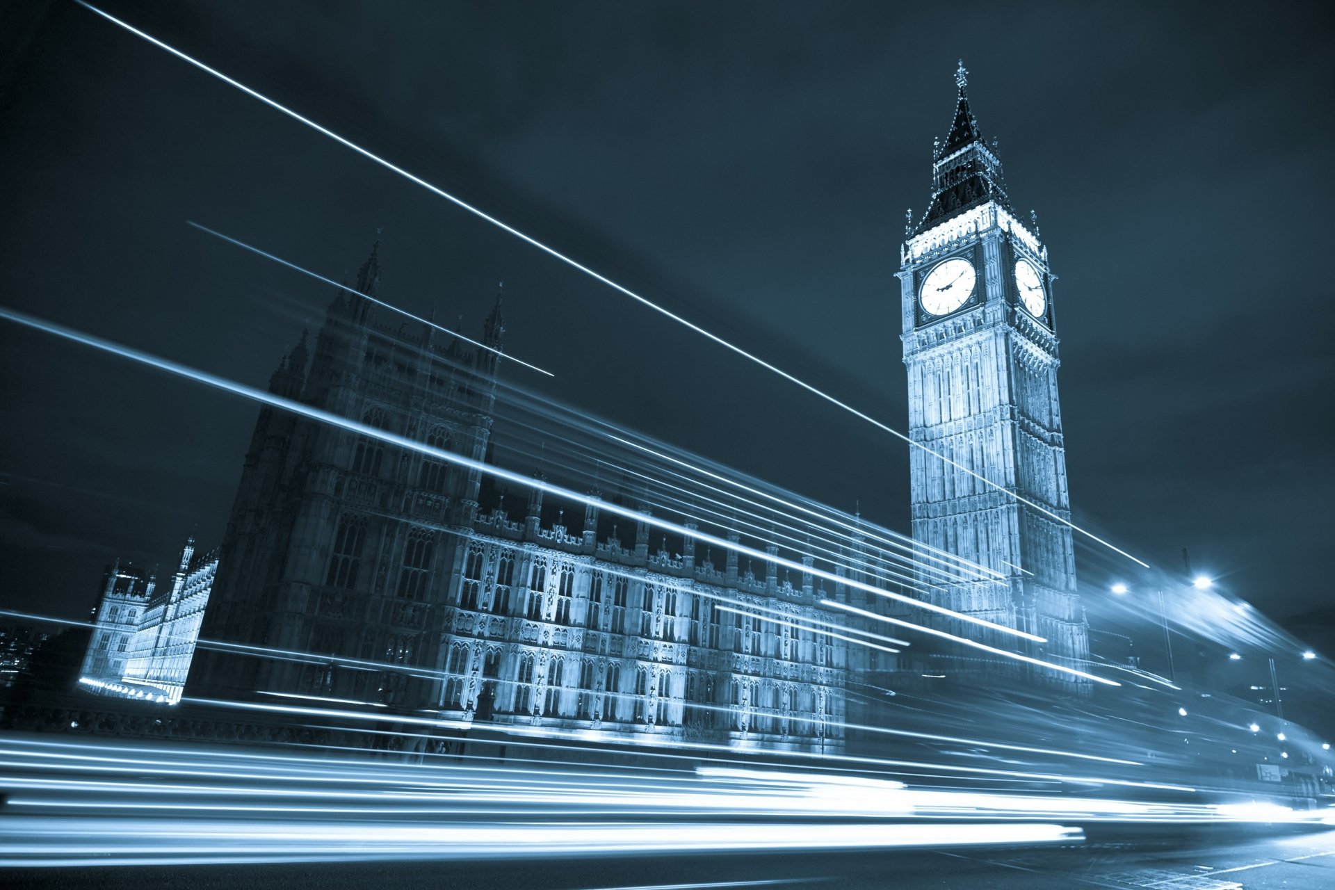 2K Quad HD PC desktop wallpaper of Big Ben and the Houses of Parliament at night, long-exposure light trails streaking across the foreground — London man-made landmark.