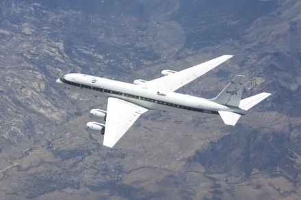 NASA's DC-8 aircraft captured in flight over a mountainous landscape, displayed as an HD PC desktop wallpaper and background.