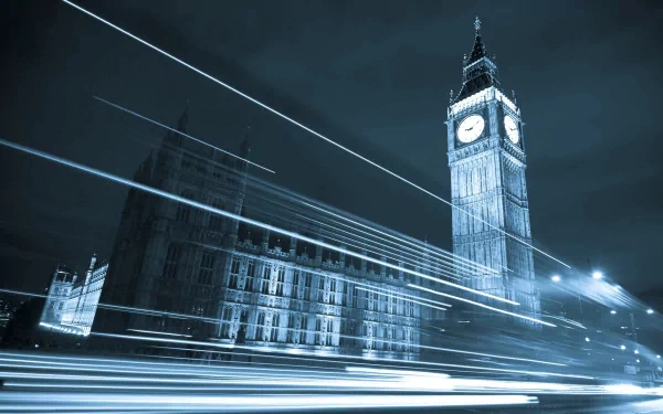 2K Quad HD PC desktop wallpaper of Big Ben and the Houses of Parliament at night, long-exposure light trails streaking across the foreground — London man-made landmark.