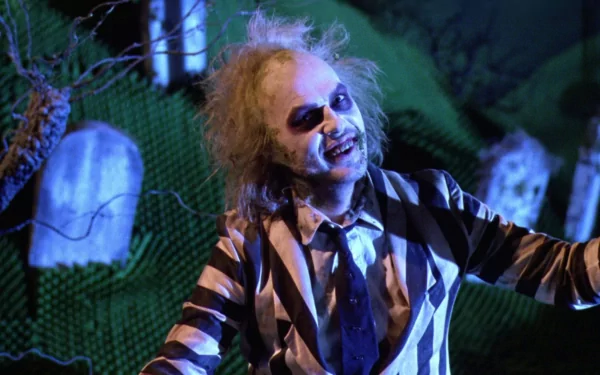 HD PC desktop wallpaper featuring Michael Keaton as Beetlejuice in his iconic black-and-white striped suit against a dark, eerie graveyard background.