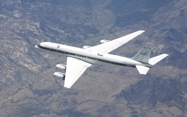 NASA's DC-8 aircraft captured in flight over a mountainous landscape, displayed as an HD PC desktop wallpaper and background.