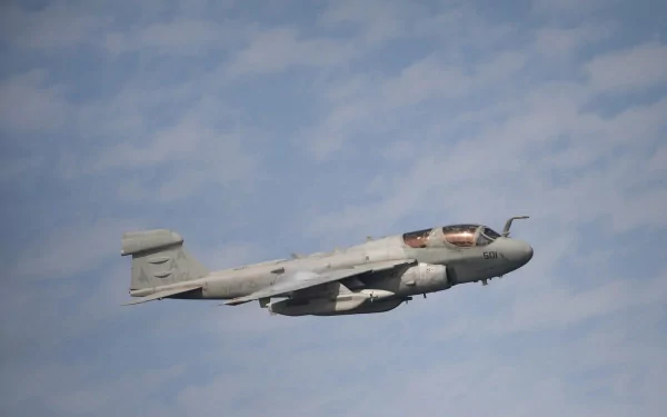 Northrop Grumman EA-6B Prowler, a military Navy aircraft, captured in flight against a partly cloudy sky, featured as an HD PC desktop wallpaper.