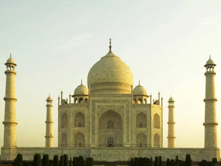 A stunning HD wallpaper featuring the majestic Taj Mahal, showcasing its intricate architecture and elegant minarets against a soft sky, embodying iconic man-made beauty.