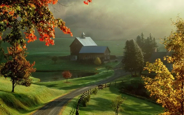 A serene farm scene featuring a rustic barn surrounded by lush greenery and autumn foliage, creating a tranquil HD desktop wallpaper and background.