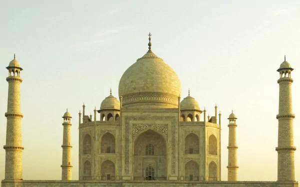 A stunning HD wallpaper featuring the majestic Taj Mahal, showcasing its intricate architecture and elegant minarets against a soft sky, embodying iconic man-made beauty.