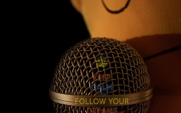 Close-up of a microphone with a motivational message inspired by The Simpsons, blending music and encouragement in a 4K Ultra HD TV show desktop wallpaper.