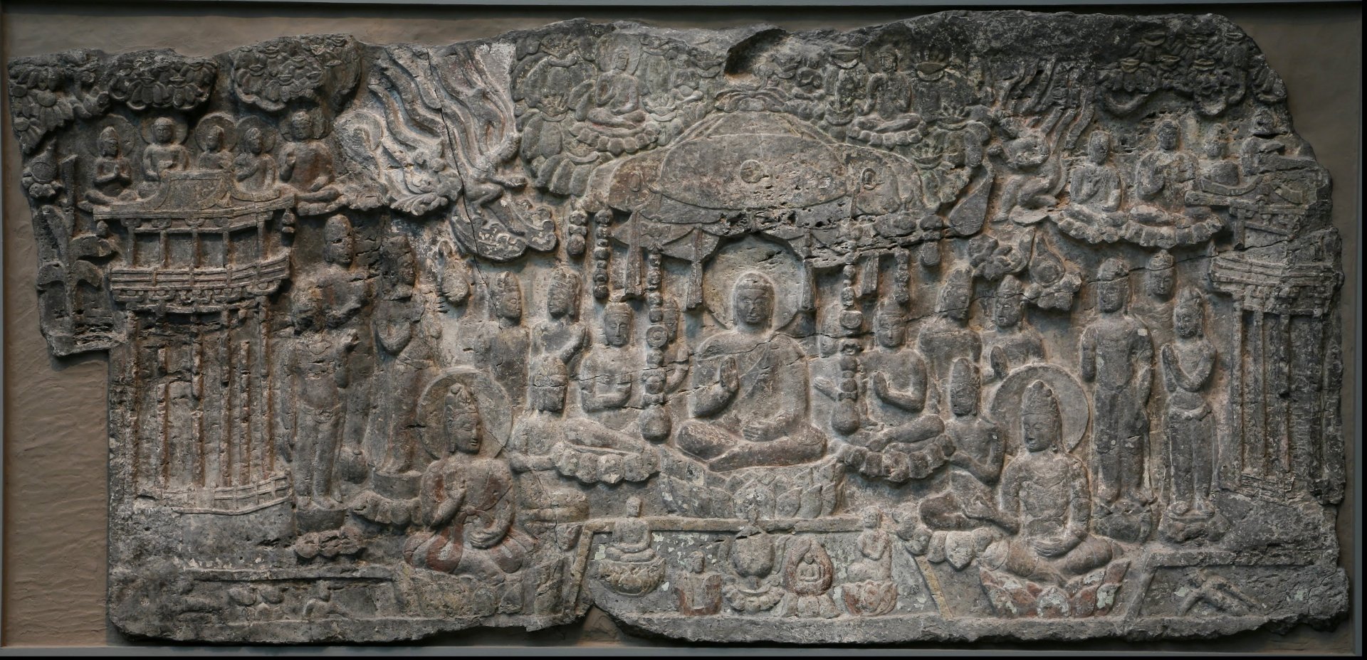 A detailed relief carving depicting Buddhist figures and symbols, showcasing the essence of Buddhism. This HD wallpaper serves as a serene backdrop for desktop use.