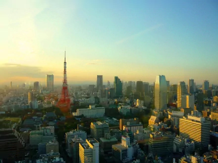 HD desktop wallpaper showcasing Tokyo Tower and Tokyo cityscape under a clear sky, highlighting the iconic man-made structure amidst urban buildings.