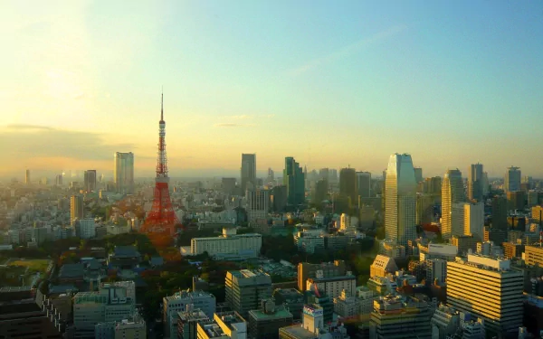 HD desktop wallpaper showcasing Tokyo Tower and Tokyo cityscape under a clear sky, highlighting the iconic man-made structure amidst urban buildings.