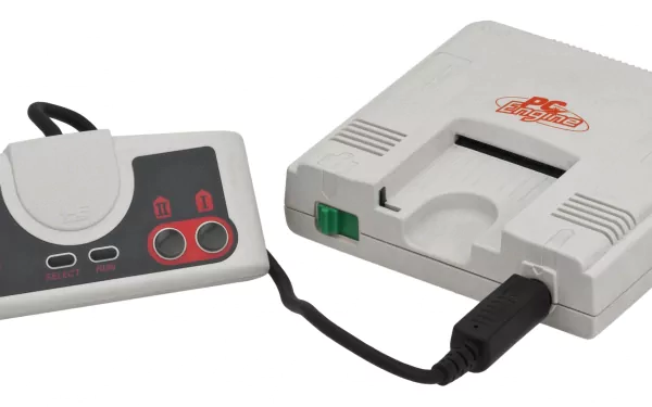 Close-up of a white PC Engine console with wired controller on white background — video game 2K Quad HD PC desktop wallpaper and background.