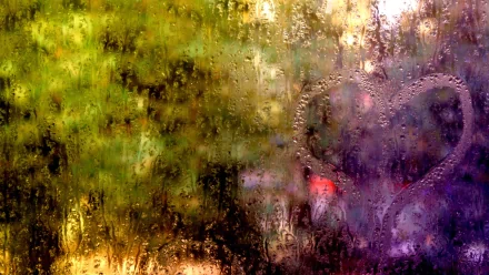 HD PC desktop wallpaper featuring a close-up photograph of raindrops on a window with a heart shape drawn in the condensation against a blurred, colorful background.