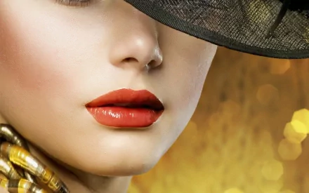 A close-up of a woman's lips, enhanced with vibrant red lipstick, set against a warm, sparkling background, creates a striking HD desktop wallpaper.