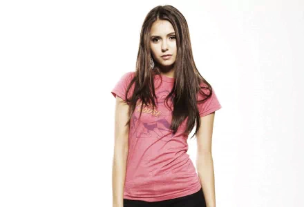 Nina Dobrev poses confidently in a pink t-shirt, captured in a high-definition PC desktop wallpaper and background.