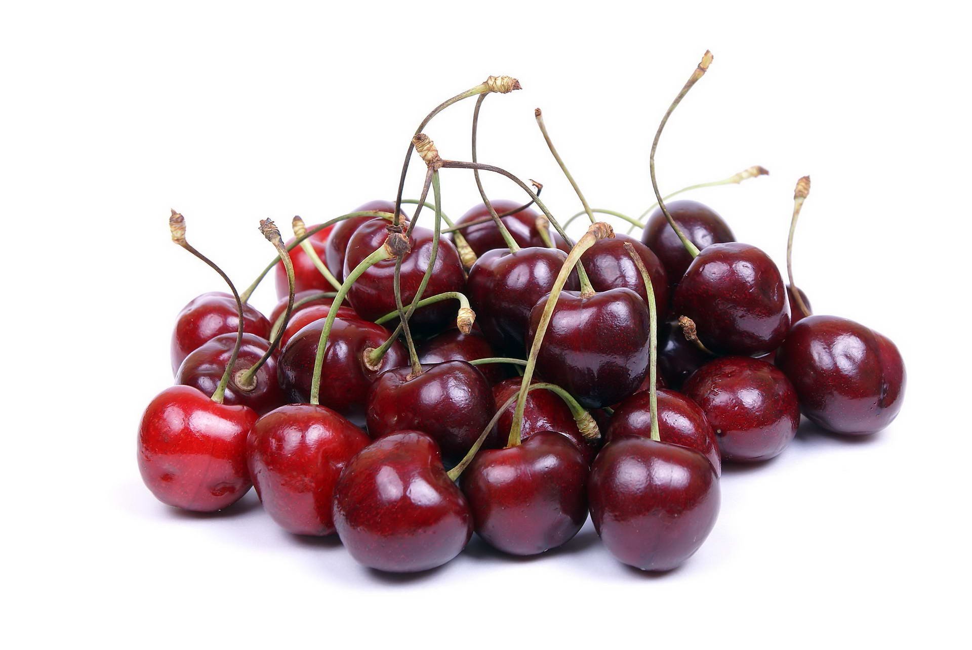 HD PC desktop wallpaper: glossy red cherries with stems piled on a white background — food, cherry.