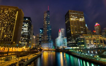 Man-made Chicago skyline at night, glowing skyscrapers reflected in the river; vibrant, high-definition PC desktop wallpaper/background.