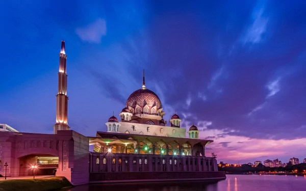 Putra Mosque in Putrajaya, Malaysia, illuminated at night with vibrant sky, reflecting on water—an HD man-made architectural landmark.