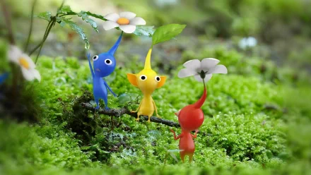 HD wallpaper of Pikmin 3 featuring red, yellow, and blue Pikmin characters on a verdant mossy background.