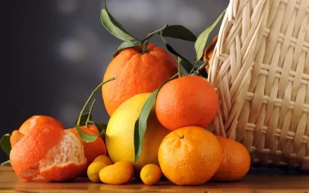 HD desktop wallpaper featuring a vibrant assortment of mandarin oranges and other citrus fruits spilling from a woven basket on a wooden surface.