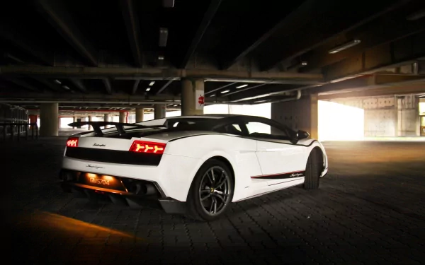 HD desktop wallpaper featuring a white Lamborghini Gallardo Superleggera parked in a dimly lit underground garage.
