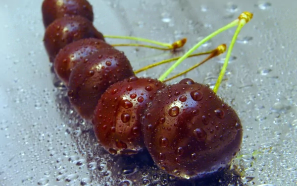 HD PC desktop wallpaper featuring a close-up of fresh cherries with water droplets on a reflective surface.