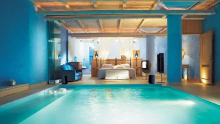 HD PC desktop wallpaper featuring a man-made indoor pool with blue walls and an elegant bedroom in the background under a wooden ceiling.