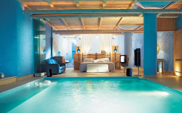 HD PC desktop wallpaper featuring a man-made indoor pool with blue walls and an elegant bedroom in the background under a wooden ceiling.