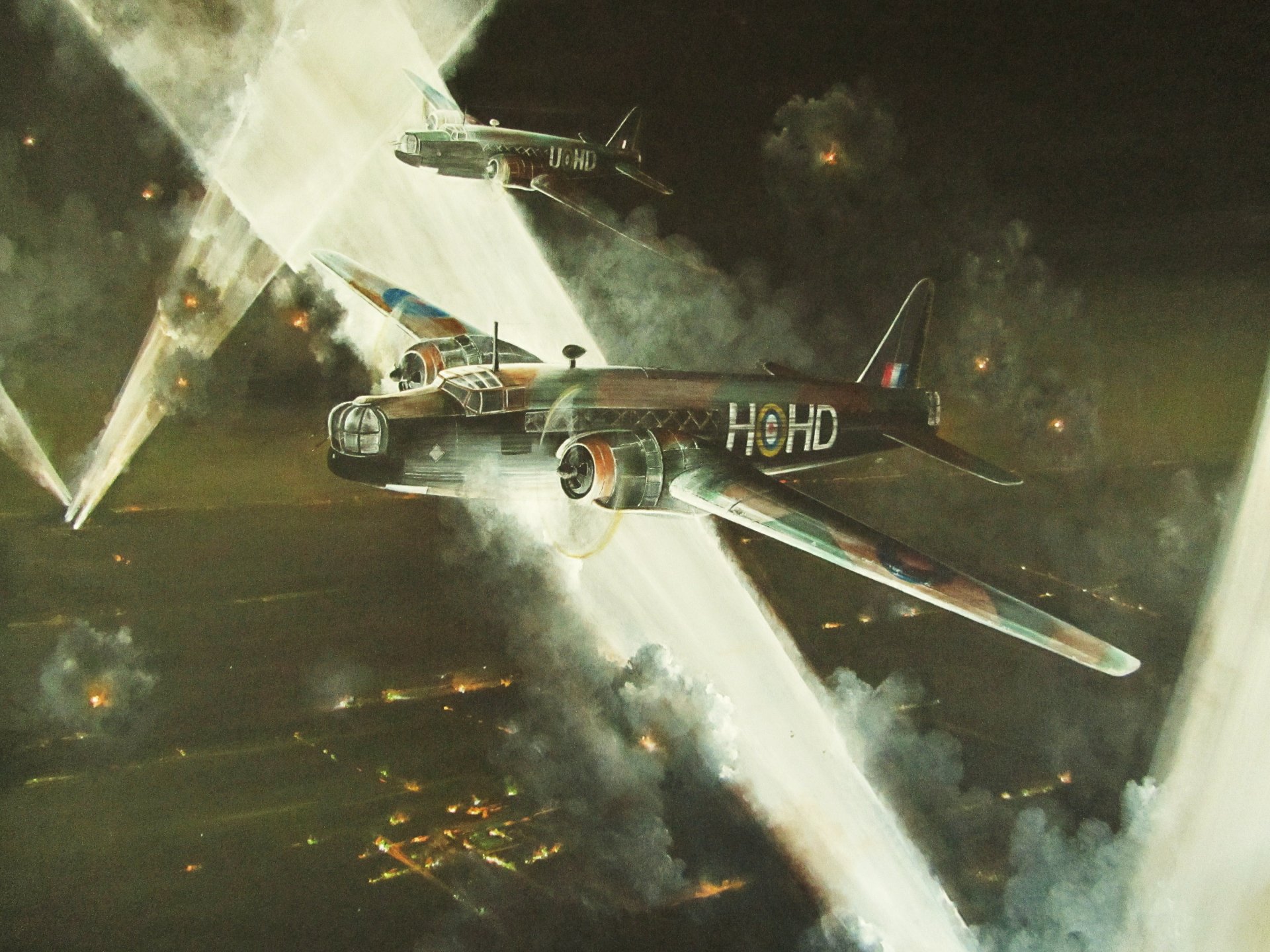 4K Ultra HD PC desktop wallpaper featuring a dramatic night scene of military aircraft in action, illuminated by searchlights and surrounded by explosions.